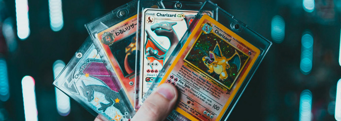A collection of rare, sealed Pokemon cards being held and fanned-out.