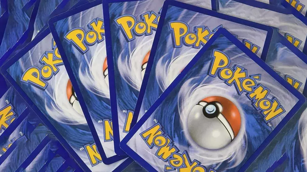 A collection of pokemon cards faced down